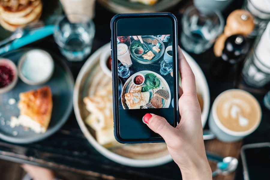 woman taking food photo at brunch table 2026 01 07 06 15 42 utc